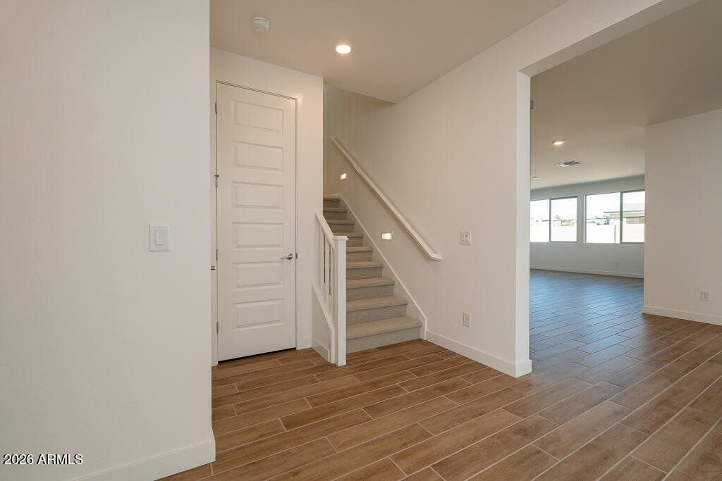 5857 South Granite Street Gilbert, AZ 85298 - Photo 10 of 20 a view of a hallway with wooden floor and staircase