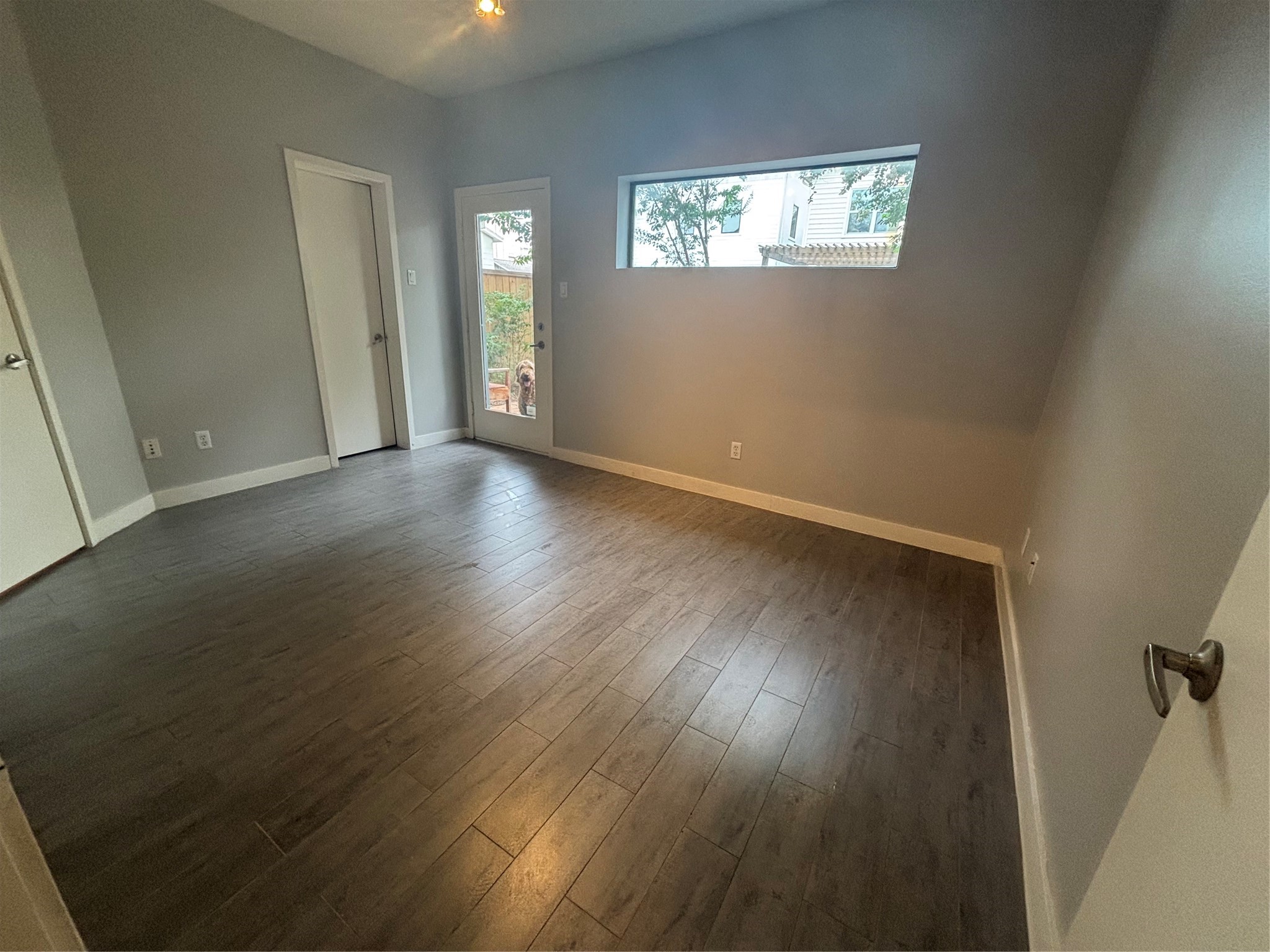 6016 Truro Street Houston, TX 77007 - Photo 23 of 26 Well-sized secondary bedrooms offering outdoor access, modern flooring, and plenty of natural light.