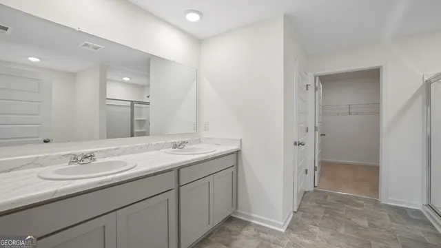 a bathroom with a granite countertop sink mirror and double