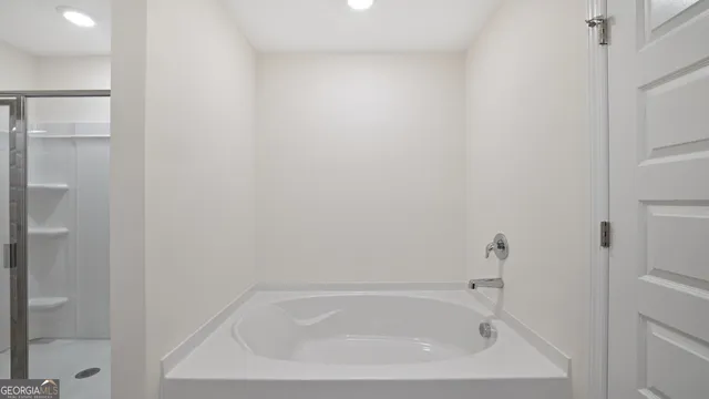 a bathroom with a glass shower door