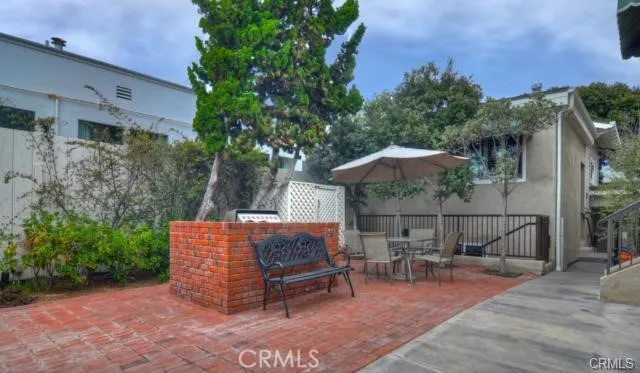 an outdoor sitting area with a bench and trees