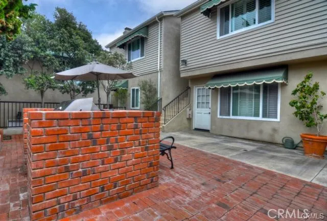 a backyard of a house with table and chairs