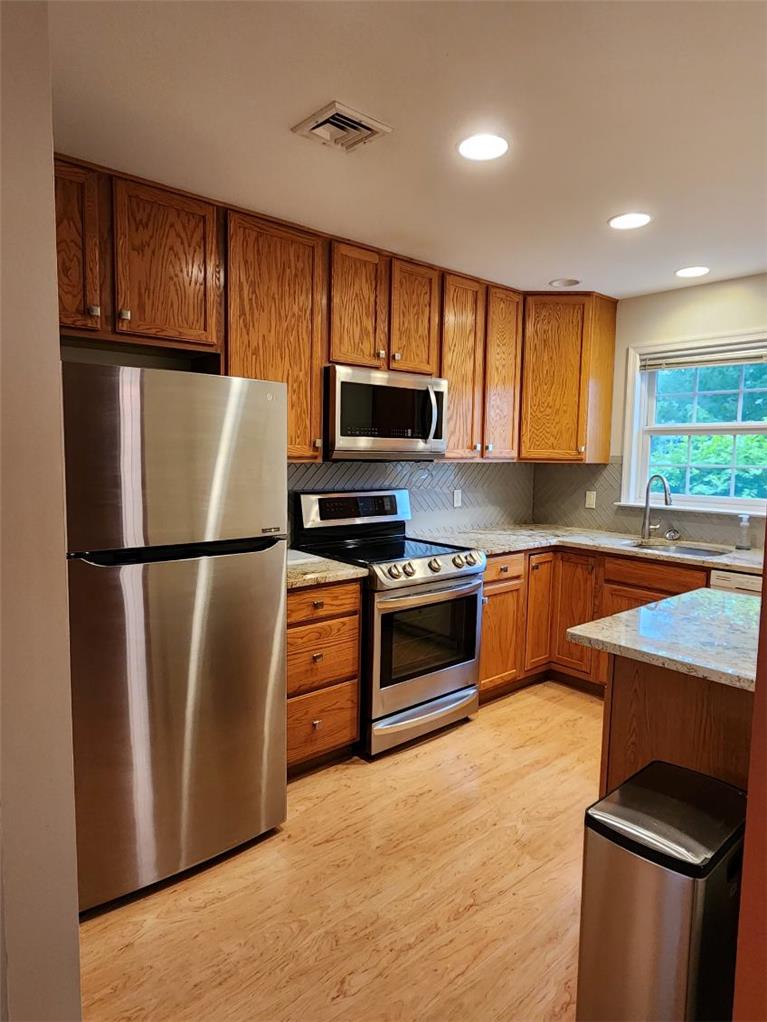 2740 Upstream Farm Road Easton, PA 18040 - Photo 2 of 13 A well-lit kitchen featuring rich wood cabinetry and gleaming stainless steel appliances.