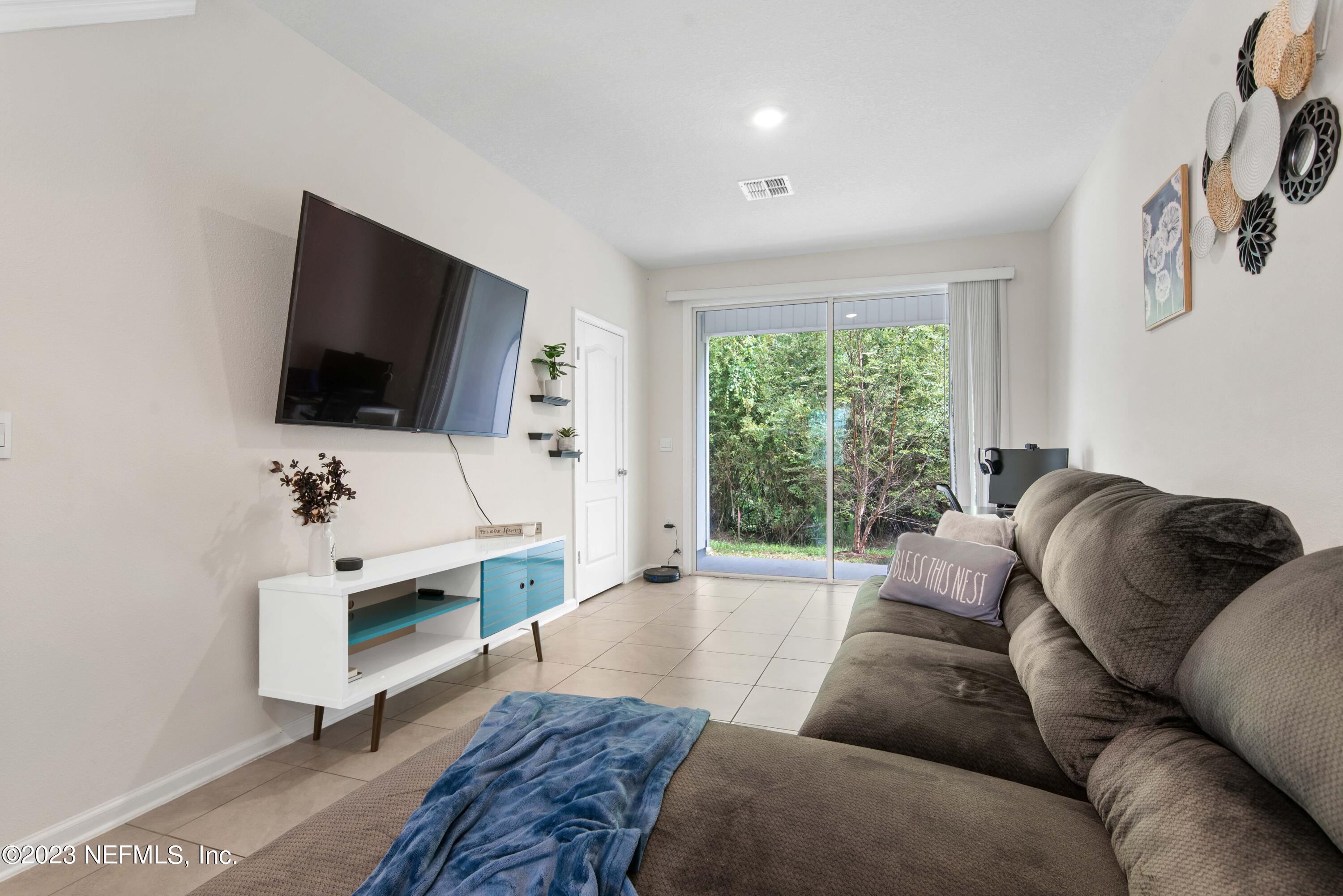 920 Rotary Road Jacksonville, FL 32211 - Photo 6 of 15 a living room with furniture and a flat screen tv