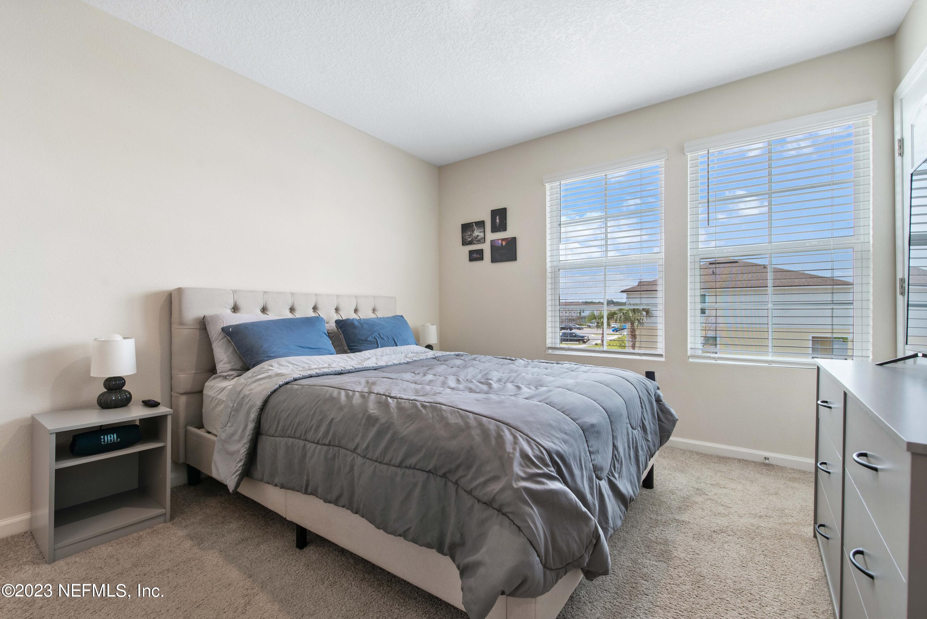 920 Rotary Road Jacksonville, FL 32211 - Photo 8 of 15 a bedroom with a bed and a large window