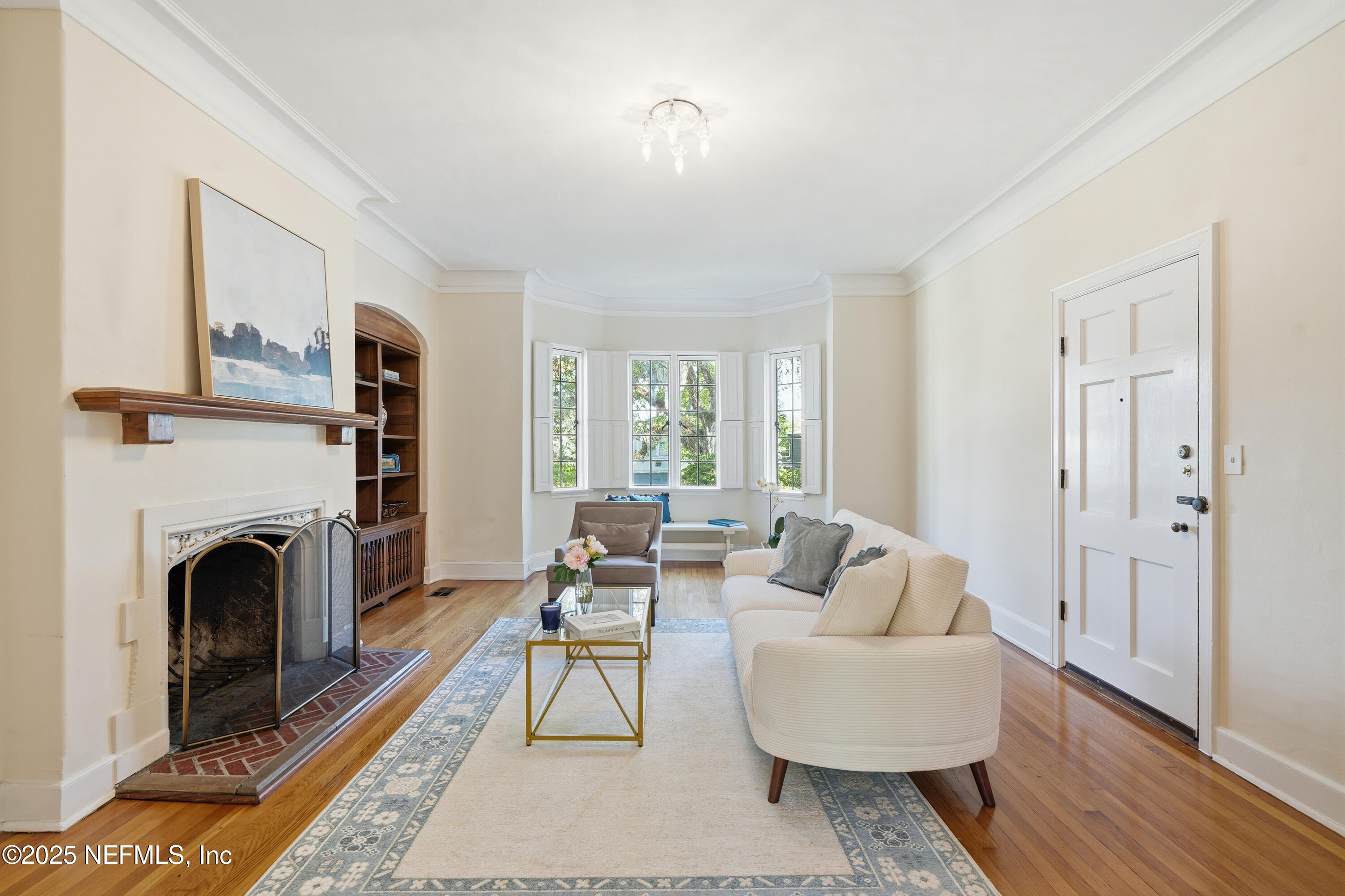 3319 Pine Street, Unit 7 Jacksonville, FL 32205 - Photo 11 of 37 a living room with furniture a fireplace and a table