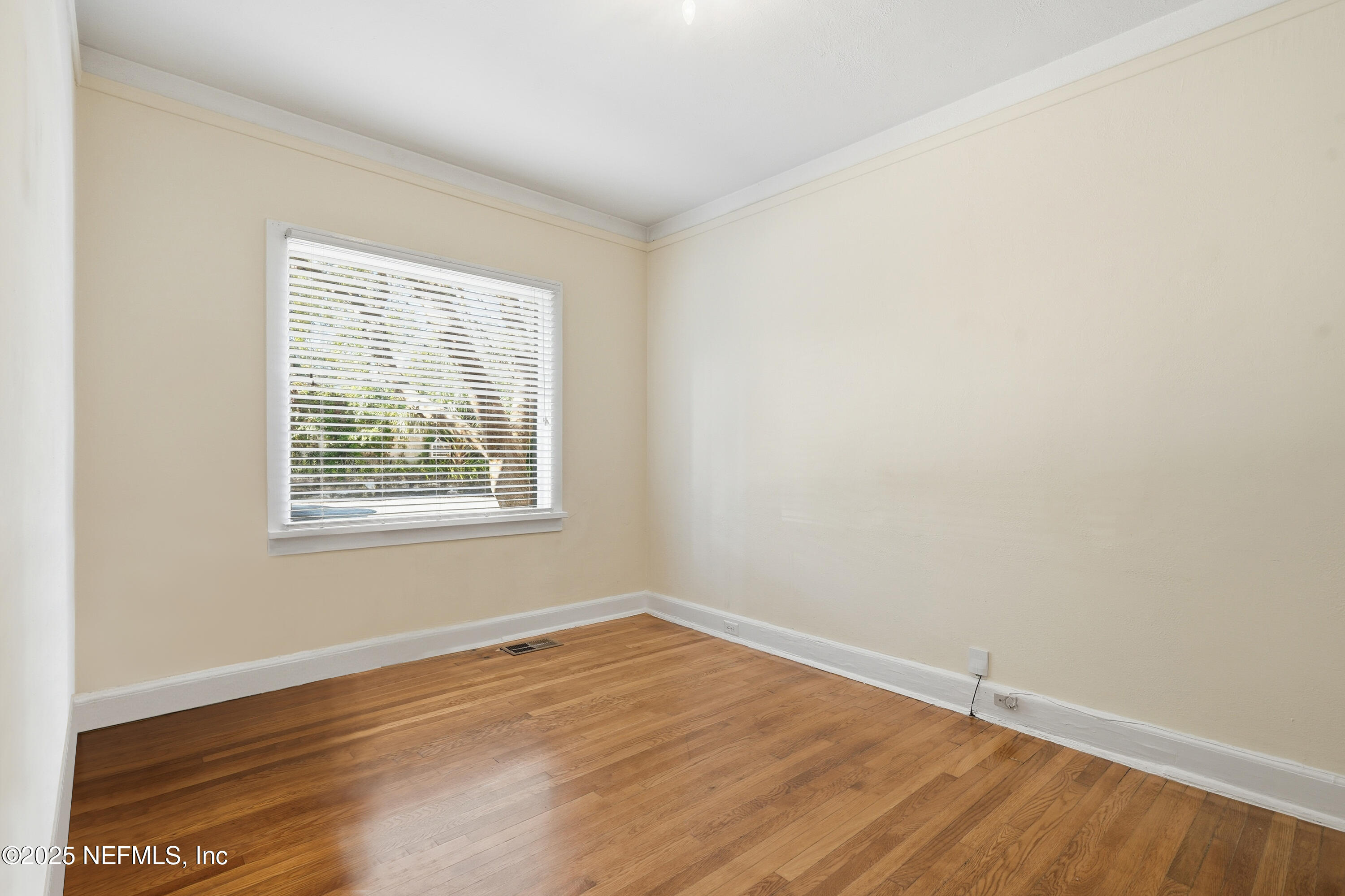 3319 Pine Street, Unit 7 Jacksonville, FL 32205 - Photo 21 of 37 an empty room with wooden floor and windows