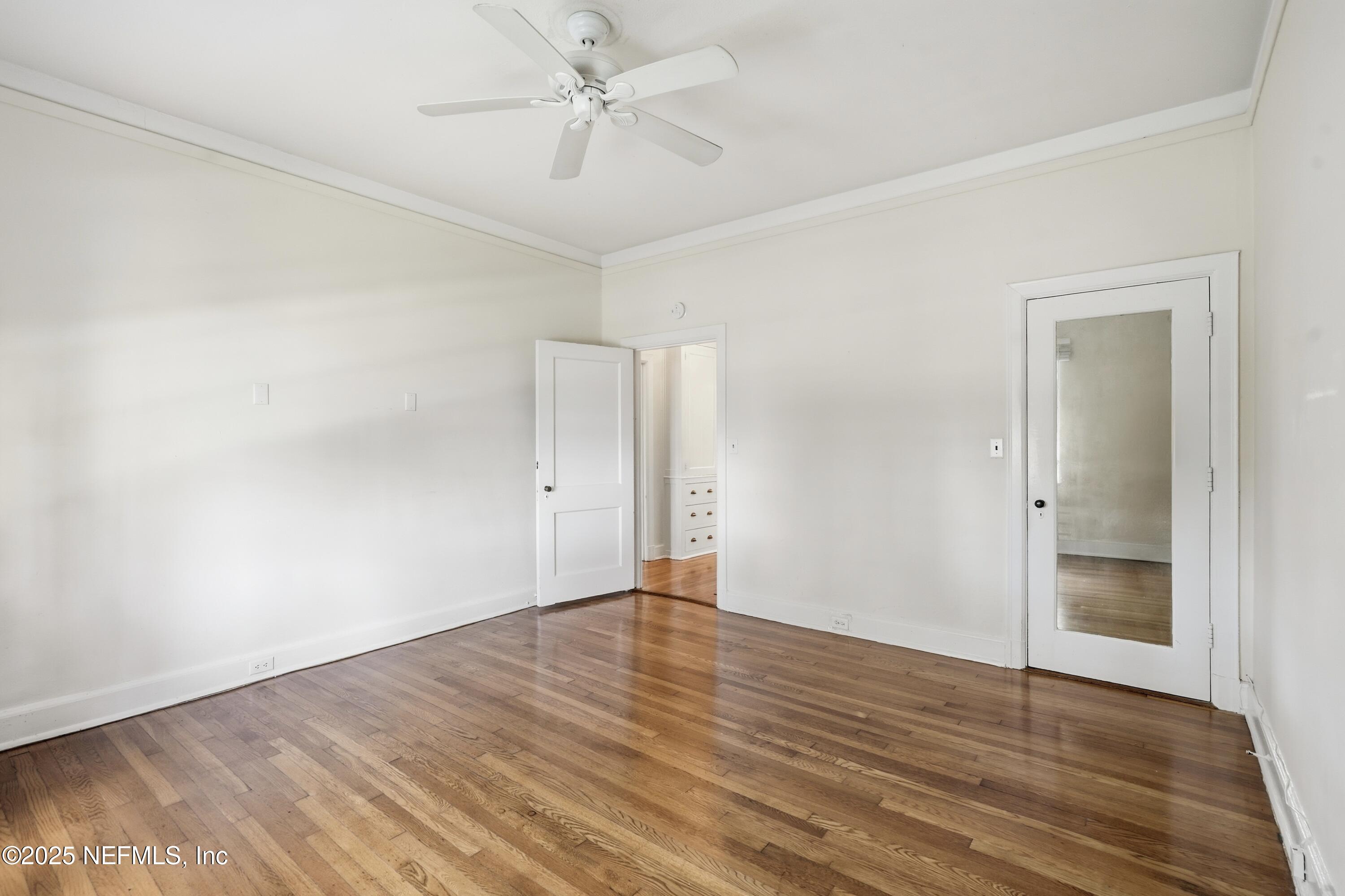 3319 Pine Street, Unit 7 Jacksonville, FL 32205 - Photo 24 of 37 an empty room with wooden floor and ceiling fan