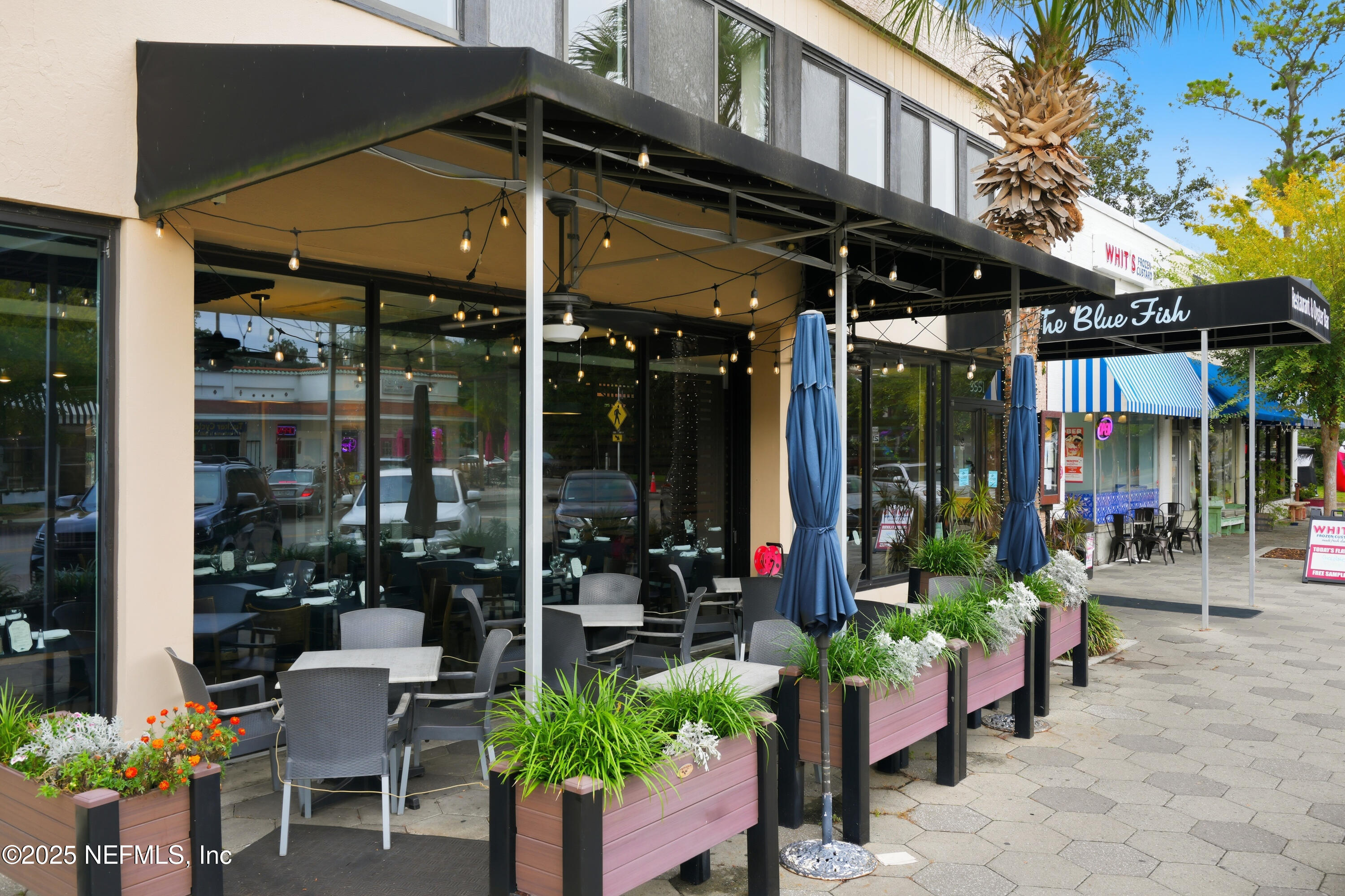 3319 Pine Street, Unit 7 Jacksonville, FL 32205 - Photo 37 of 37 a view of the patio with a table and chairs and potted plants