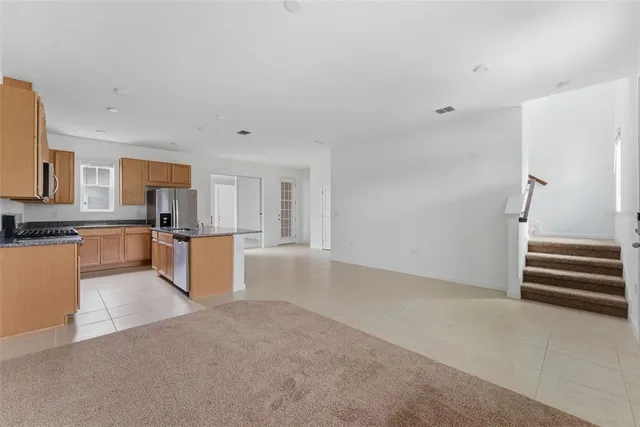 a kitchen with stainless steel appliances a refrigerator and a stove top oven