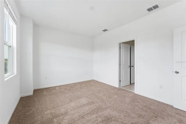 an empty room with a kitchen and a sink