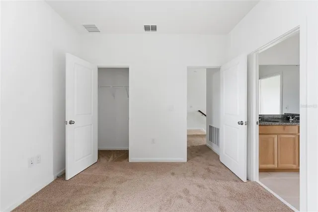 a bathroom with a granite countertop sink and mirror