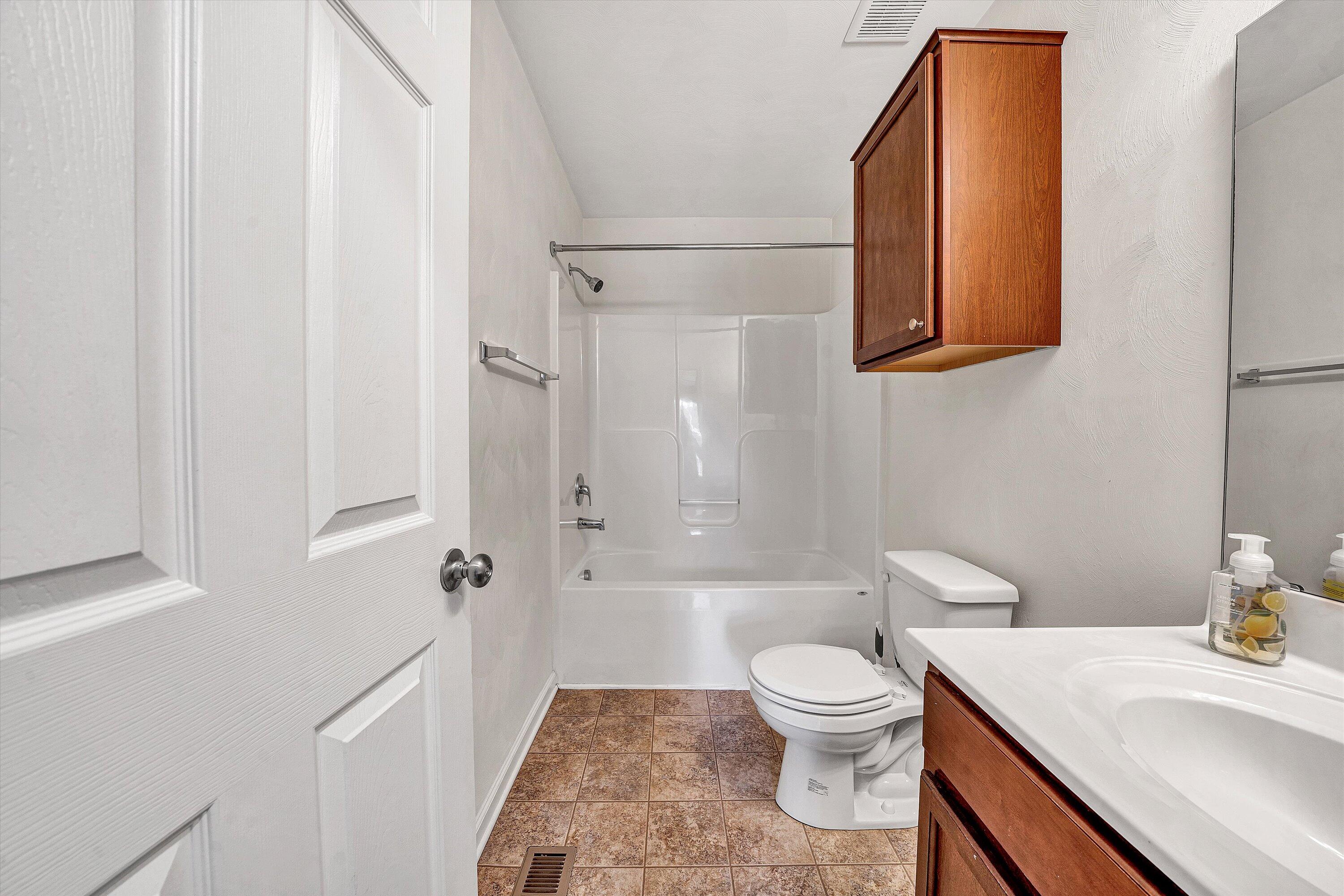 555 Old Fort Road Rocky Mount, VA 24151 - Photo 13 of 35 a bathroom with a granite countertop toilet a sink and a mirror