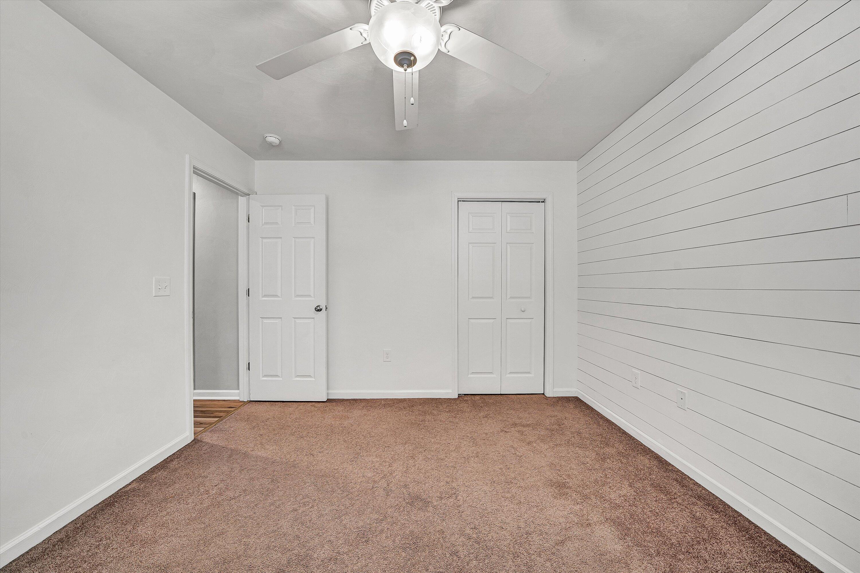 555 Old Fort Road Rocky Mount, VA 24151 - Photo 16 of 35 an empty room with chandelier fan and windows