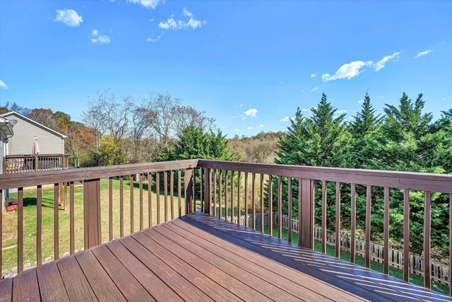 a view of balcony with wooden floor and fence