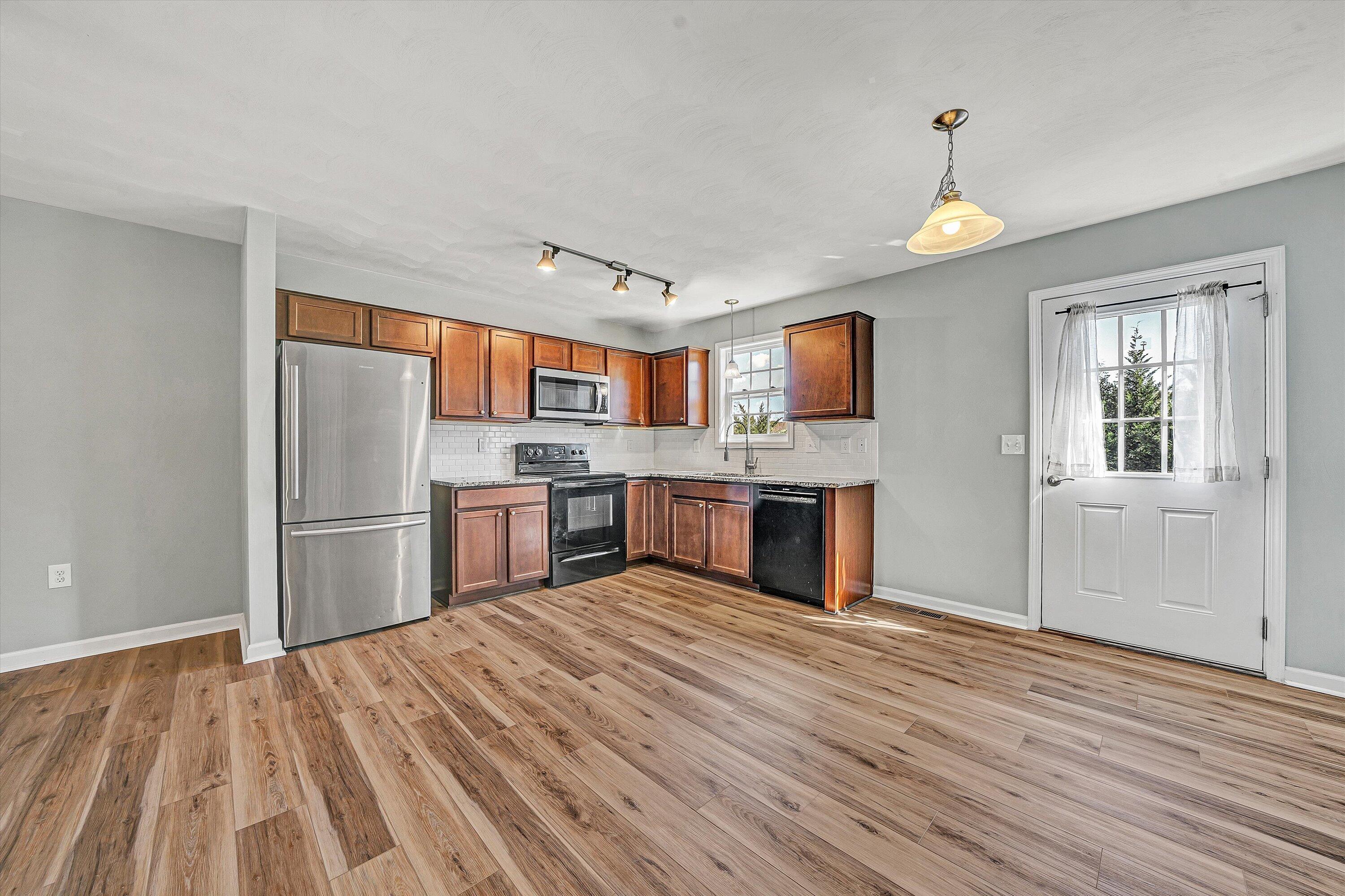 555 Old Fort Road Rocky Mount, VA 24151 - Photo 6 of 35 a kitchen with stainless steel appliances granite countertop a refrigerator and a stove top oven