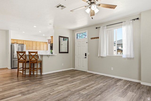 1177 Northfield Road, Unit 26 Cedar City, UT 84721 - Photo 3 of 45 Open-concept living space featuring wood-finish flooring, a ceiling fan, and a front entry door with decorative glass