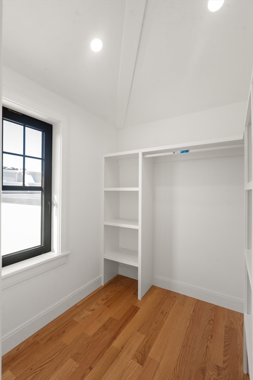 9 Sydney Street, Unit 4 Boston, MA 02125 - Photo 11 of 23 a view of an empty room with a window and wooden floor