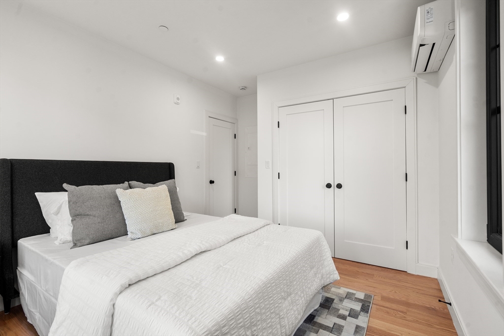 9 Sydney Street, Unit 4 Boston, MA 02125 - Photo 13 of 23 a bedroom with bed and wooden floor