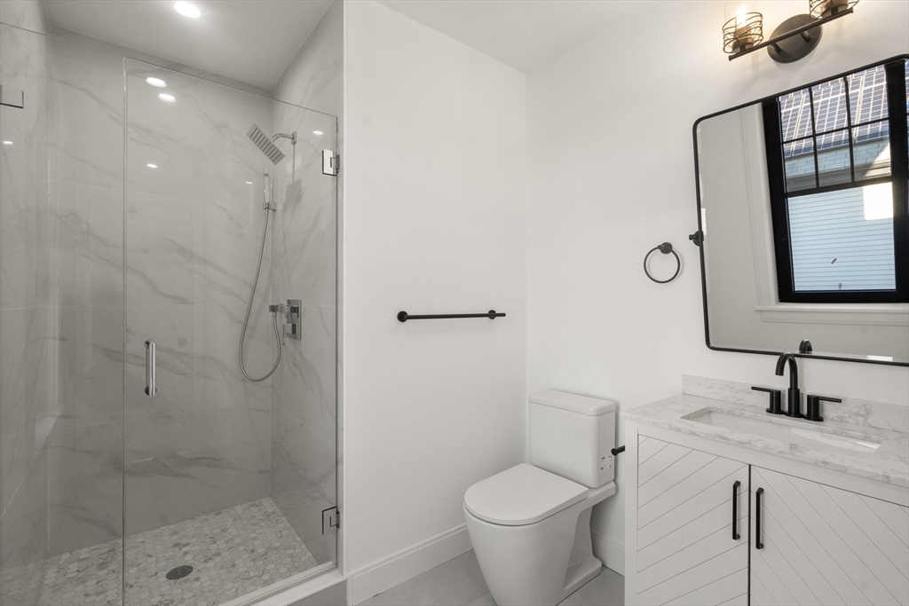 9 Sydney Street, Unit 4 Boston, MA 02125 - Photo 16 of 23 a bathroom with a shower toilet and sink