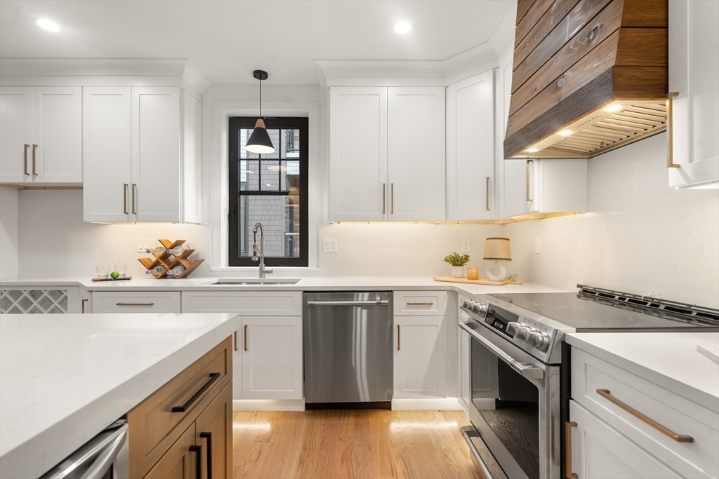 9 Sydney Street, Unit 4 Boston, MA 02125 - Photo 3 of 23 a kitchen with stainless steel appliances granite countertop a sink stove and cabinets