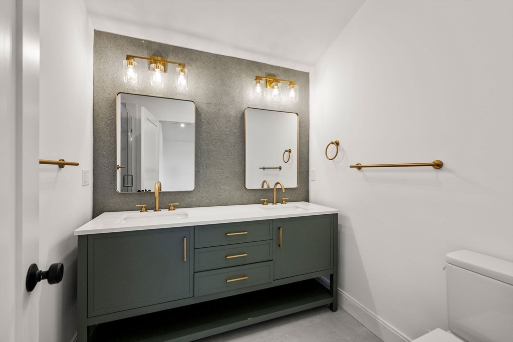 9 Sydney Street, Unit 4 Boston, MA 02125 - Photo 9 of 23 a bathroom with a double vanity sink and a mirror