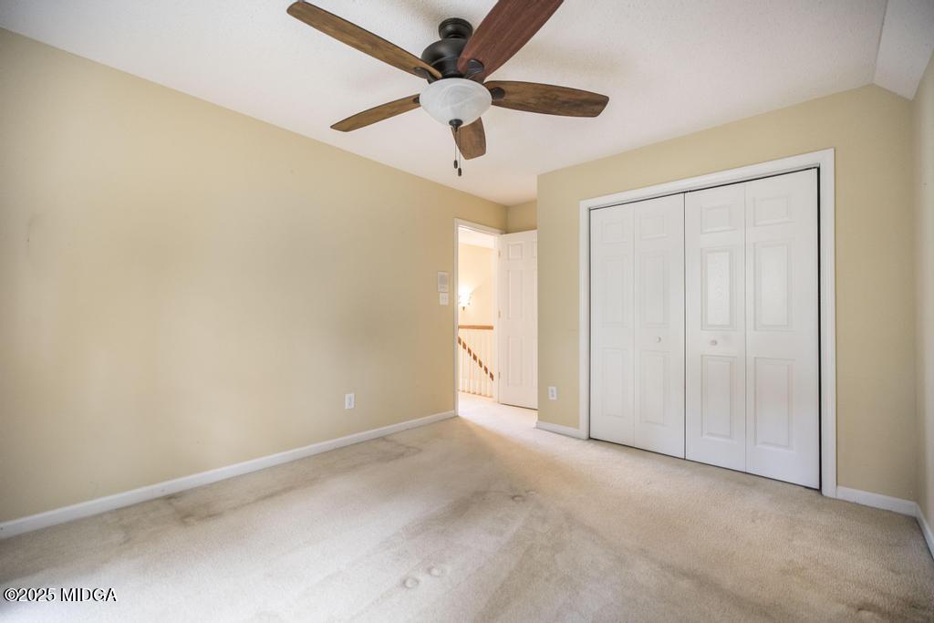 578 Edgefield Way Macon, GA 31210 - Photo 14 of 42 an empty room with a ceiling fan and a window