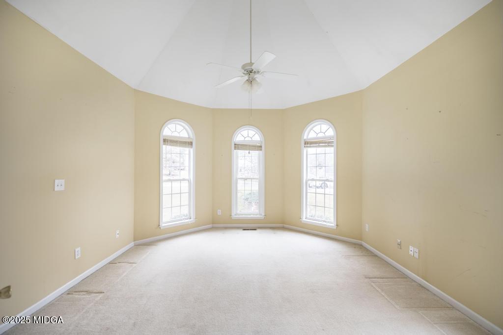 578 Edgefield Way Macon, GA 31210 - Photo 23 of 42 an empty room with windows and ceiling fan