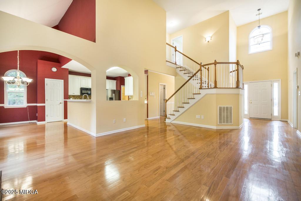 578 Edgefield Way Macon, GA 31210 - Photo 36 of 42 a view of a livingroom with wooden floor and kitchen view