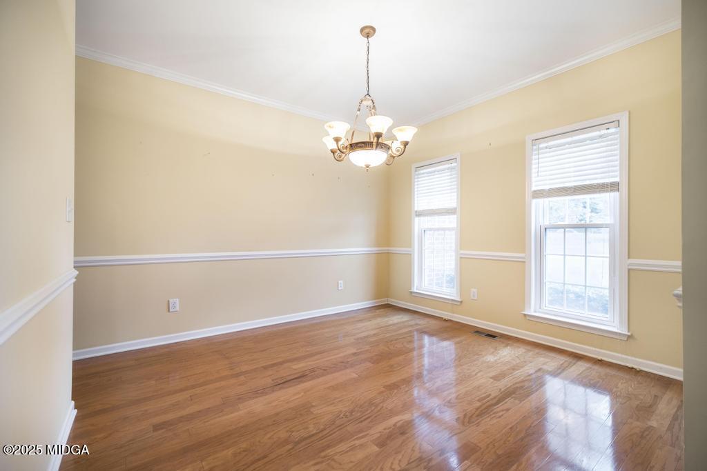 578 Edgefield Way Macon, GA 31210 - Photo 38 of 42 an empty room with wooden floor cabinet and windows