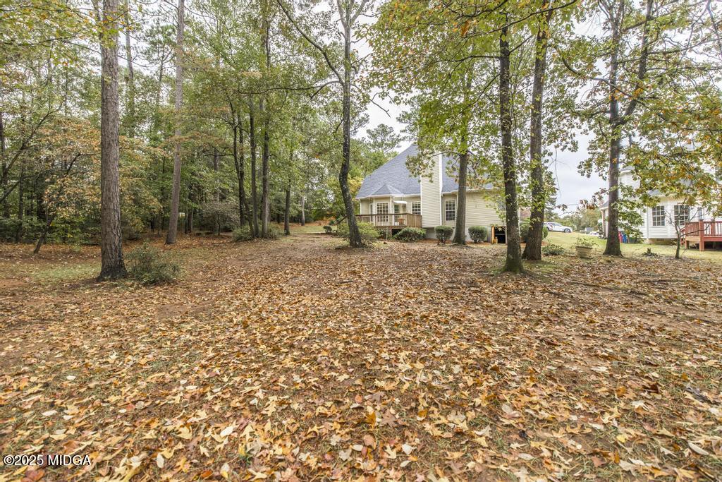 578 Edgefield Way Macon, GA 31210 - Photo 8 of 42 a backyard of a house with large trees and covered with wooden fence