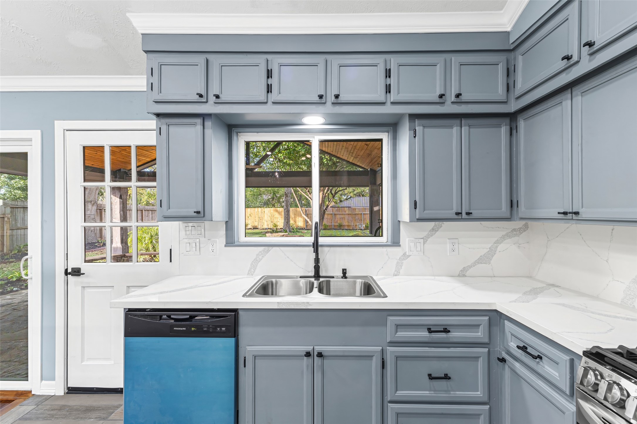 5402 Libbey Drive Houston, TX 77092 - Photo 12 of 43 a kitchen with granite countertop a sink and a window