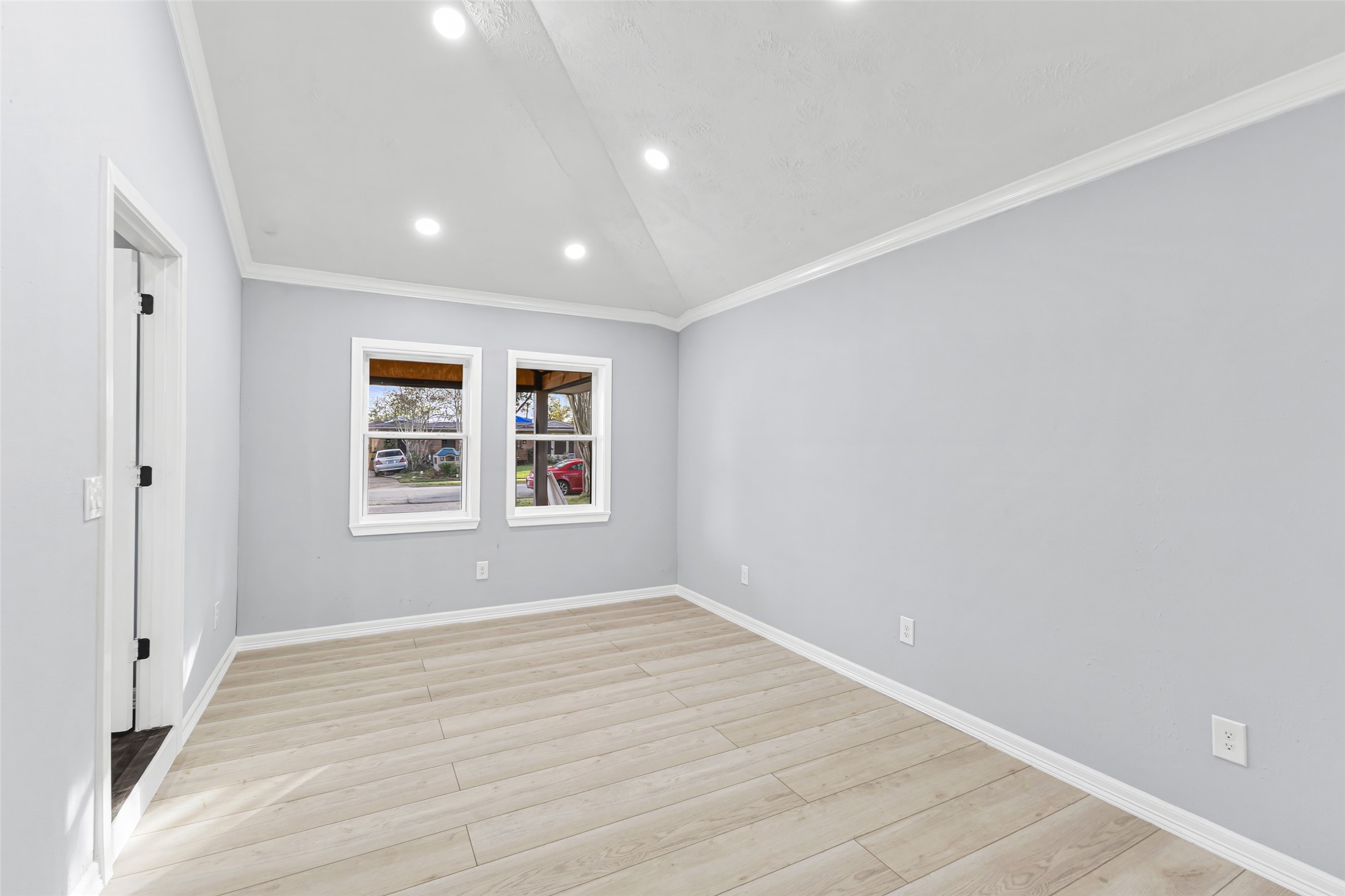 5402 Libbey Drive Houston, TX 77092 - Photo 14 of 43 an empty room with wooden floor and windows
