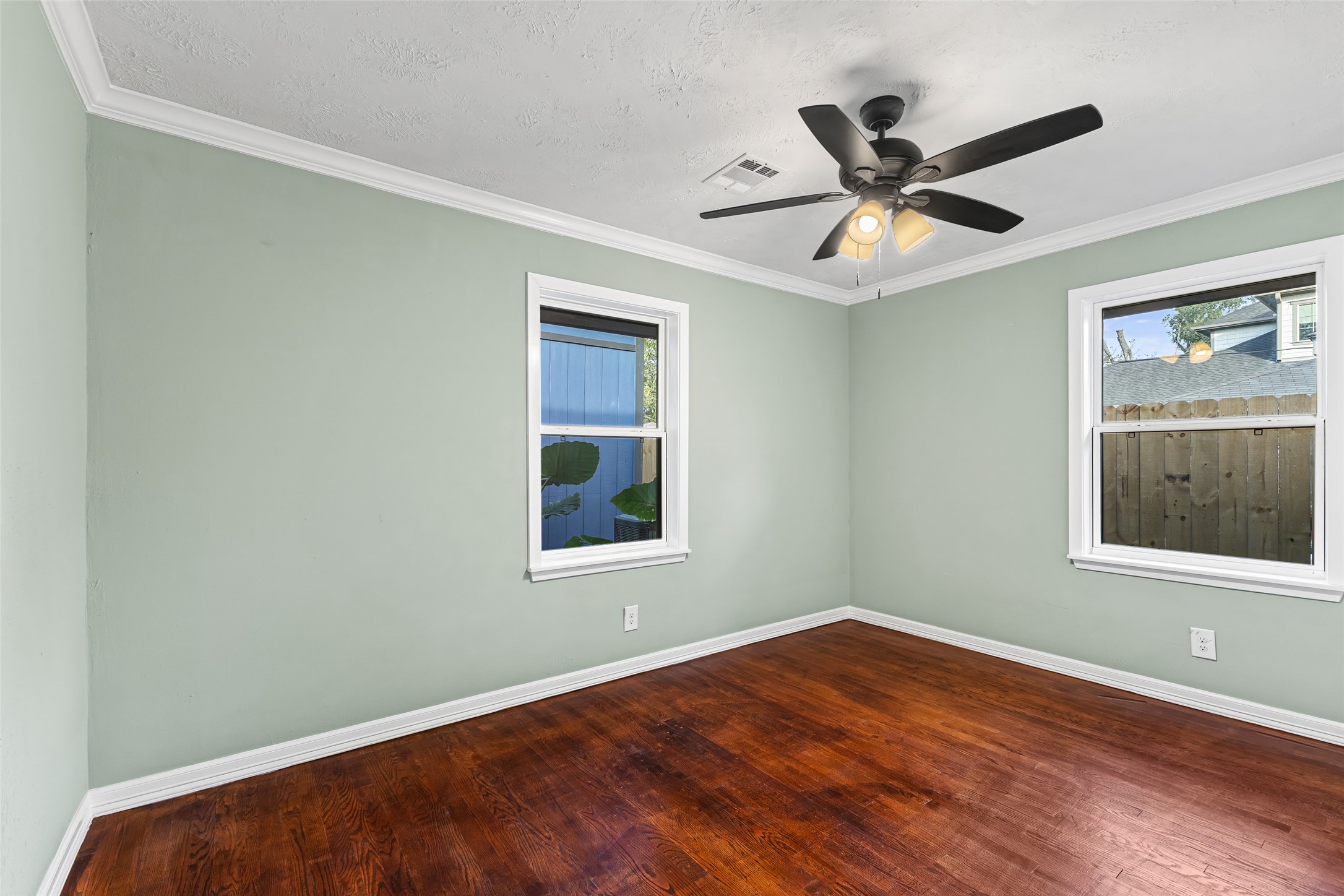 5402 Libbey Drive Houston, TX 77092 - Photo 19 of 43 a view of an empty room with wooden floor and a window
