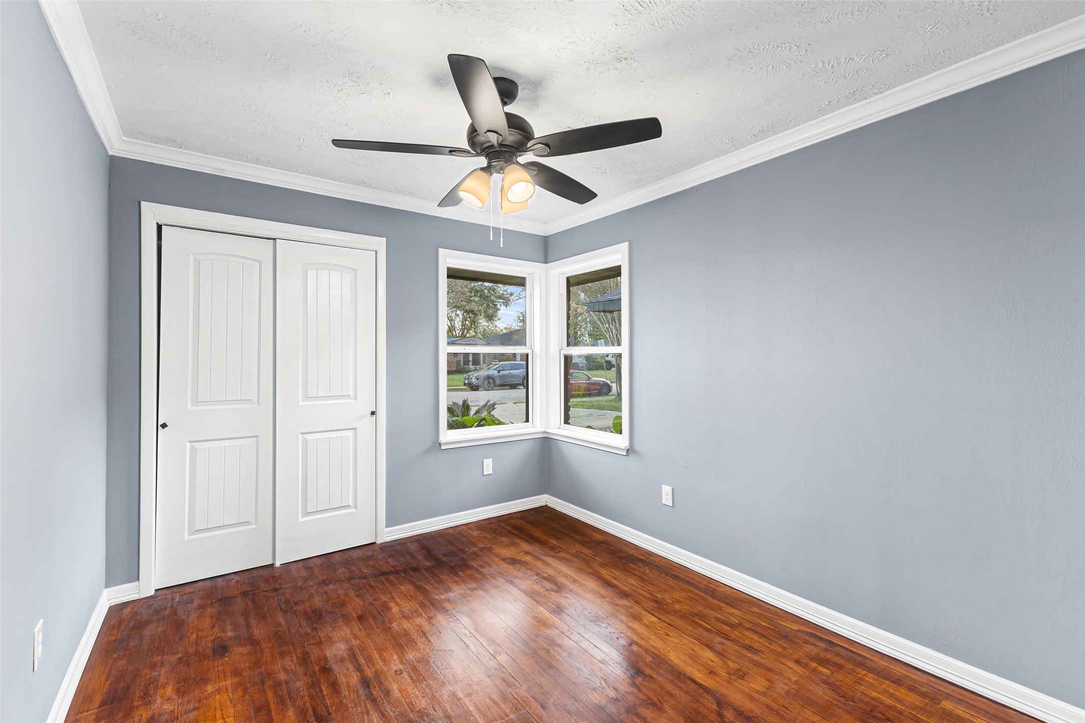5402 Libbey Drive Houston, TX 77092 - Photo 31 of 43 a view of empty room with wooden floor and ceiling fan