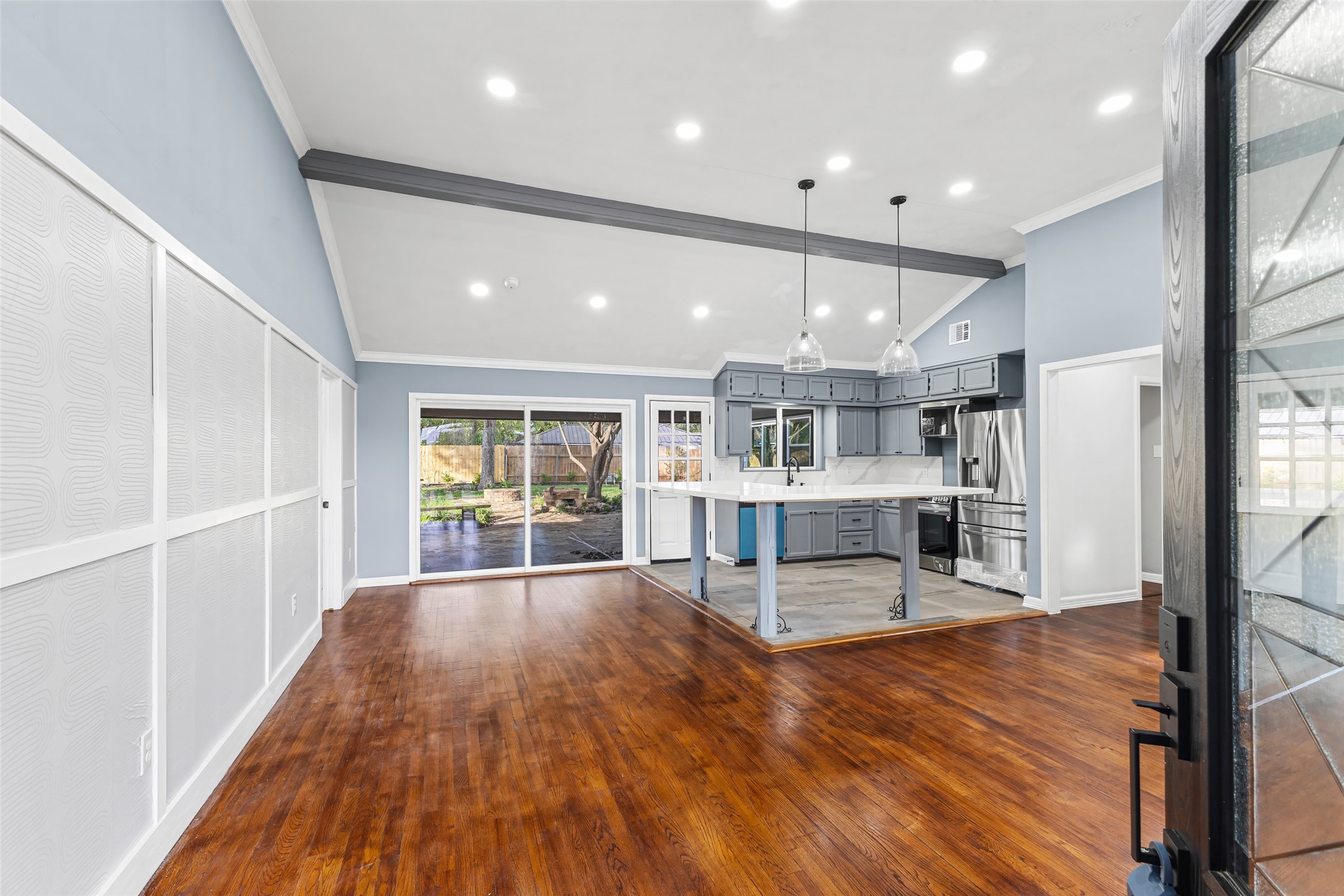 5402 Libbey Drive Houston, TX 77092 - Photo 5 of 43 a living room with stainless steel appliances furniture large windows and wooden floor