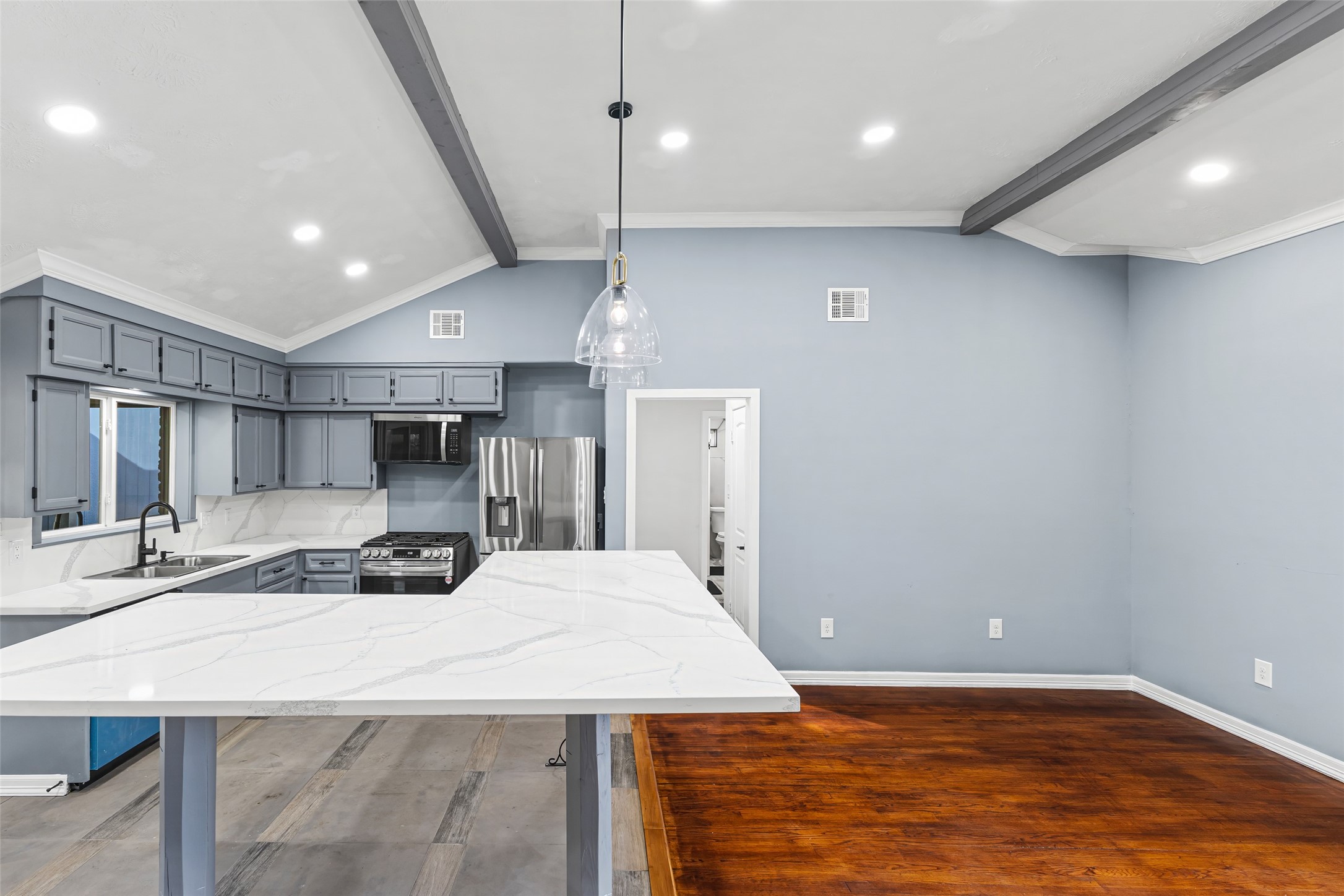 5402 Libbey Drive Houston, TX 77092 - Photo 7 of 43 a large kitchen with kitchen island a sink stainless steel appliances and cabinets