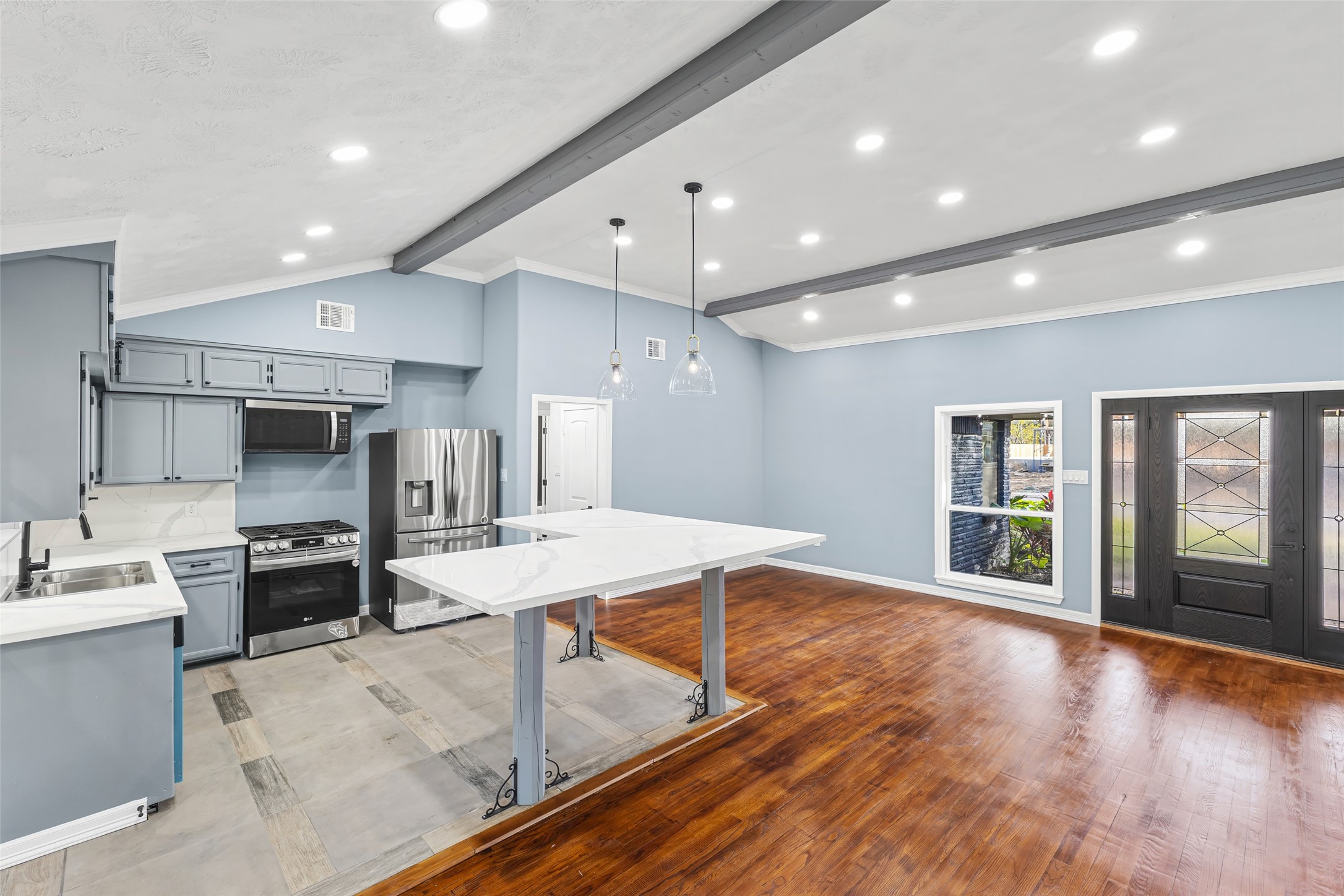 5402 Libbey Drive Houston, TX 77092 - Photo 8 of 43 a large kitchen with stainless steel appliances lots of counter space and wooden floor