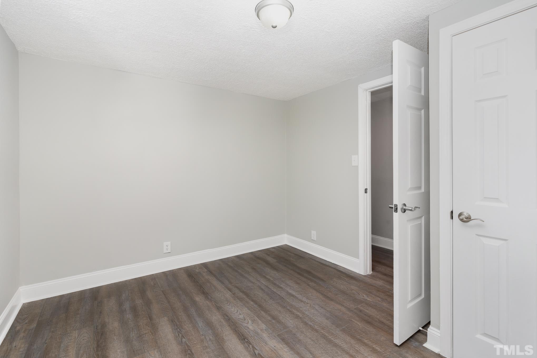 1510 Axum Road Garner, NC 27529 - Photo 15 of 22 a view of an empty room with wooden floor