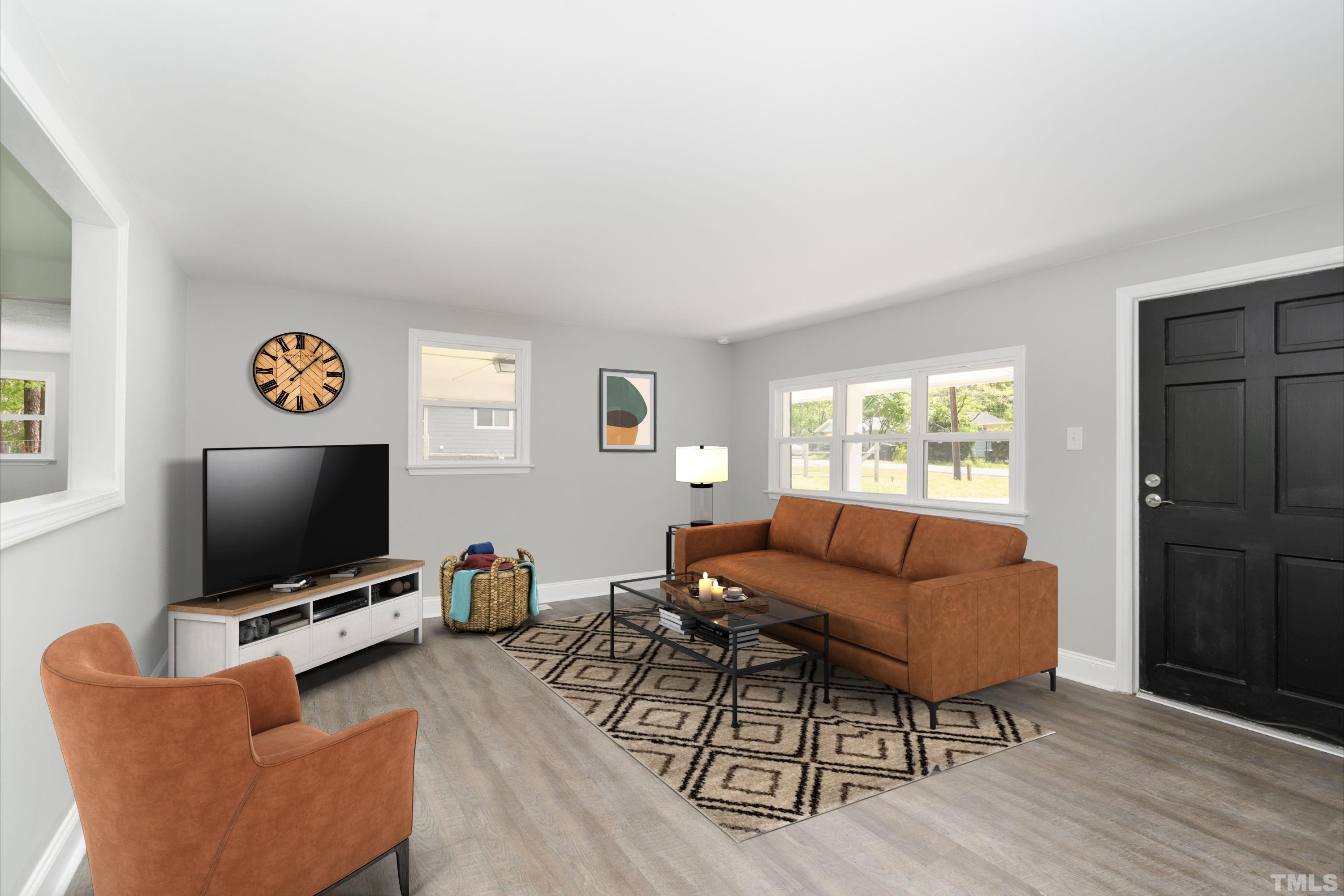 1510 Axum Road Garner, NC 27529 - Photo 5 of 22 a living room with furniture and a flat screen tv