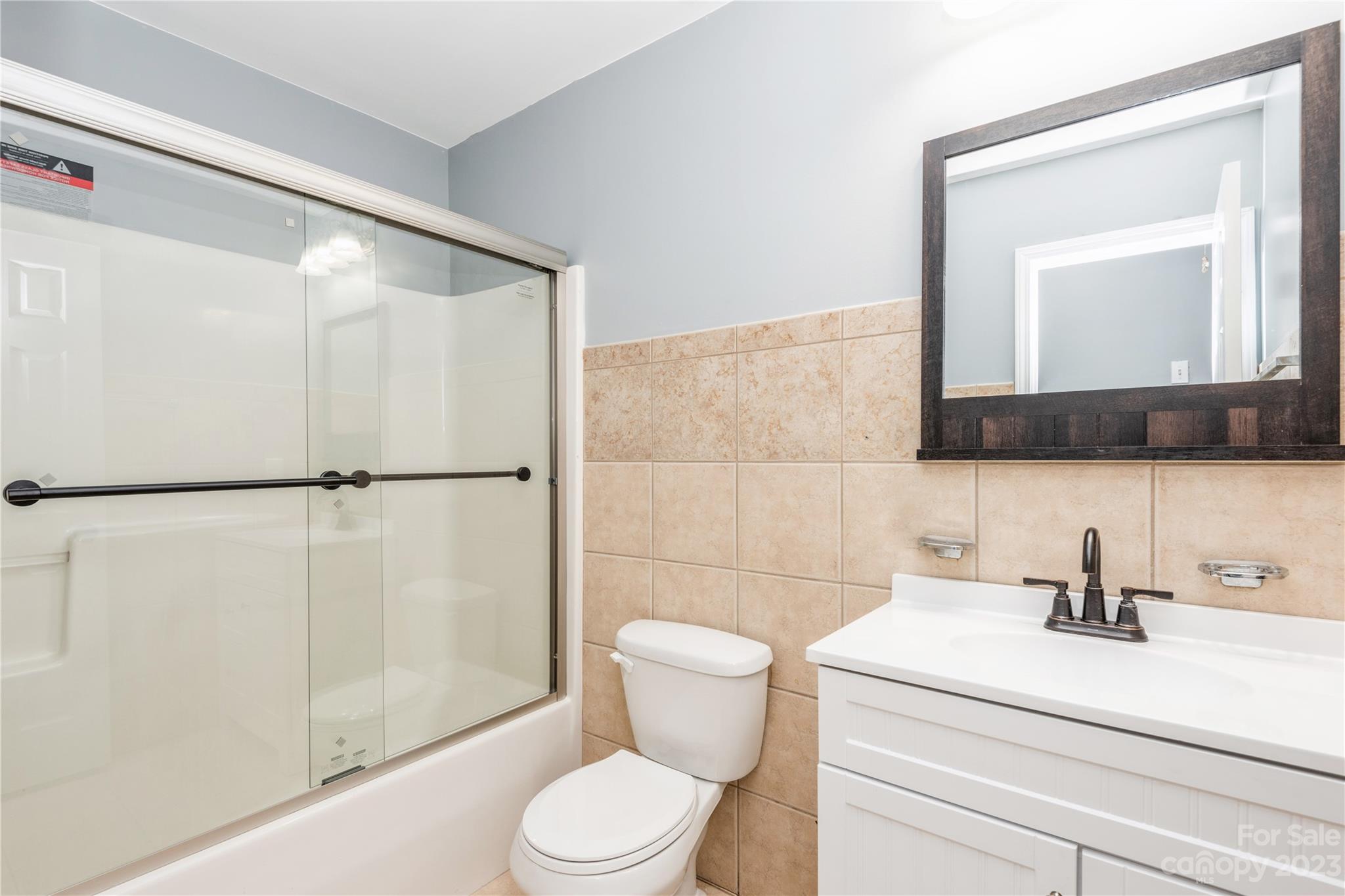 125 Rhyne Station Road Charlotte, NC 28214 - Photo 14 of 26 a bathroom with a toilet a sink and a mirror