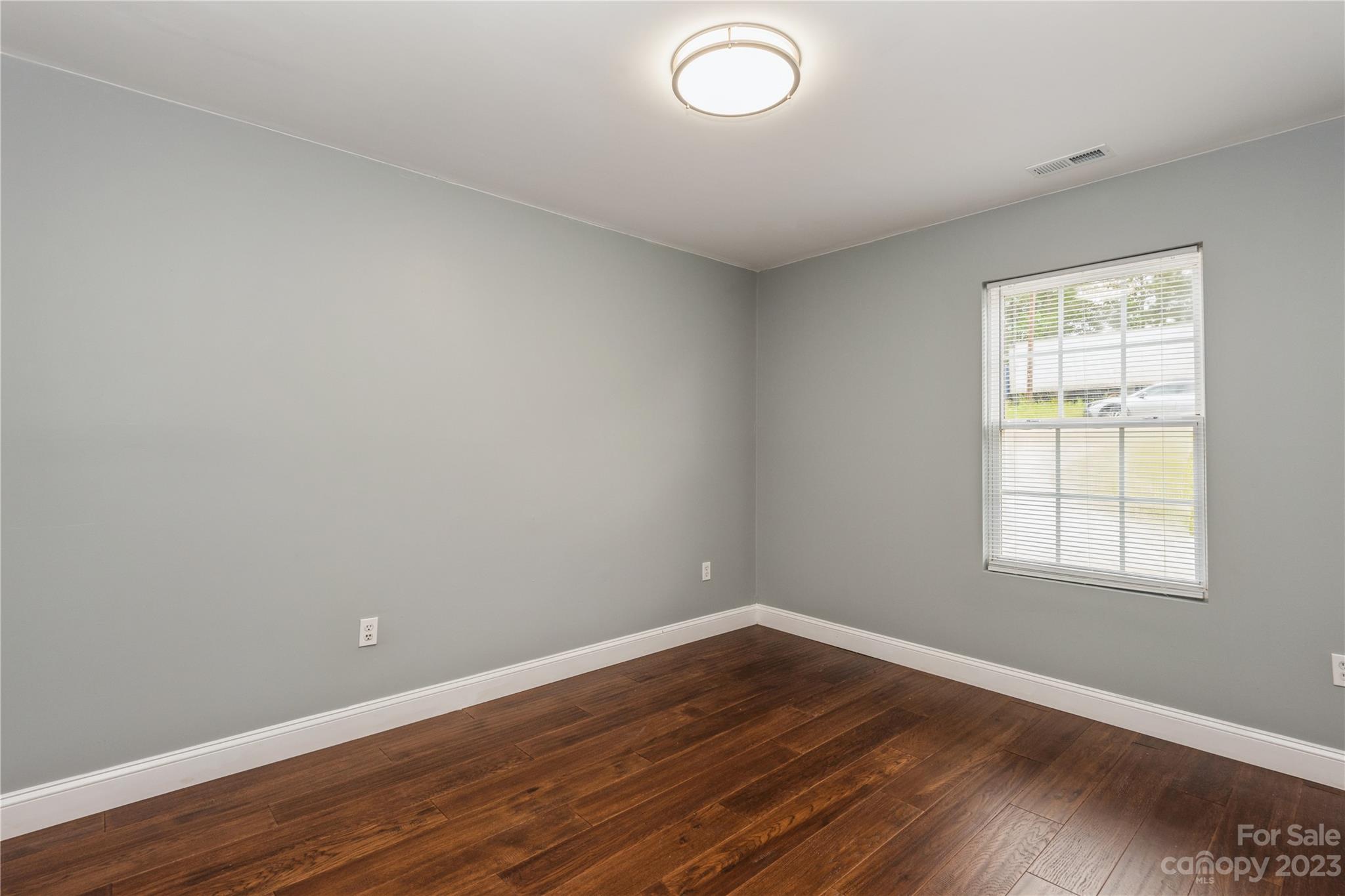 125 Rhyne Station Road Charlotte, NC 28214 - Photo 15 of 26 an empty room with wooden floor and windows