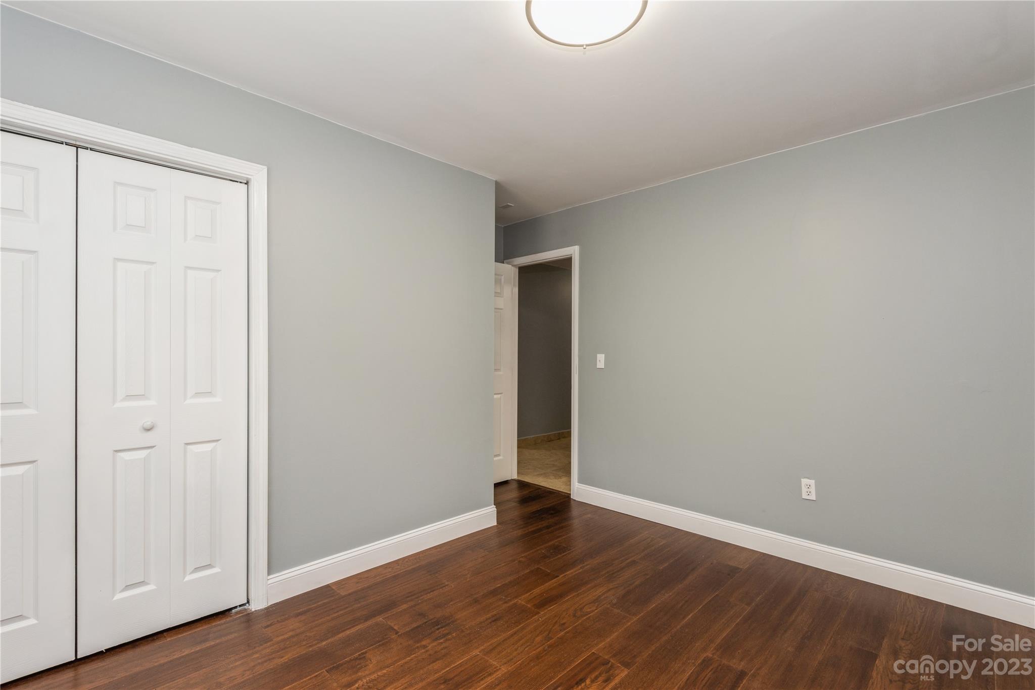 125 Rhyne Station Road Charlotte, NC 28214 - Photo 16 of 26 a view of an empty room with wooden floor and closet