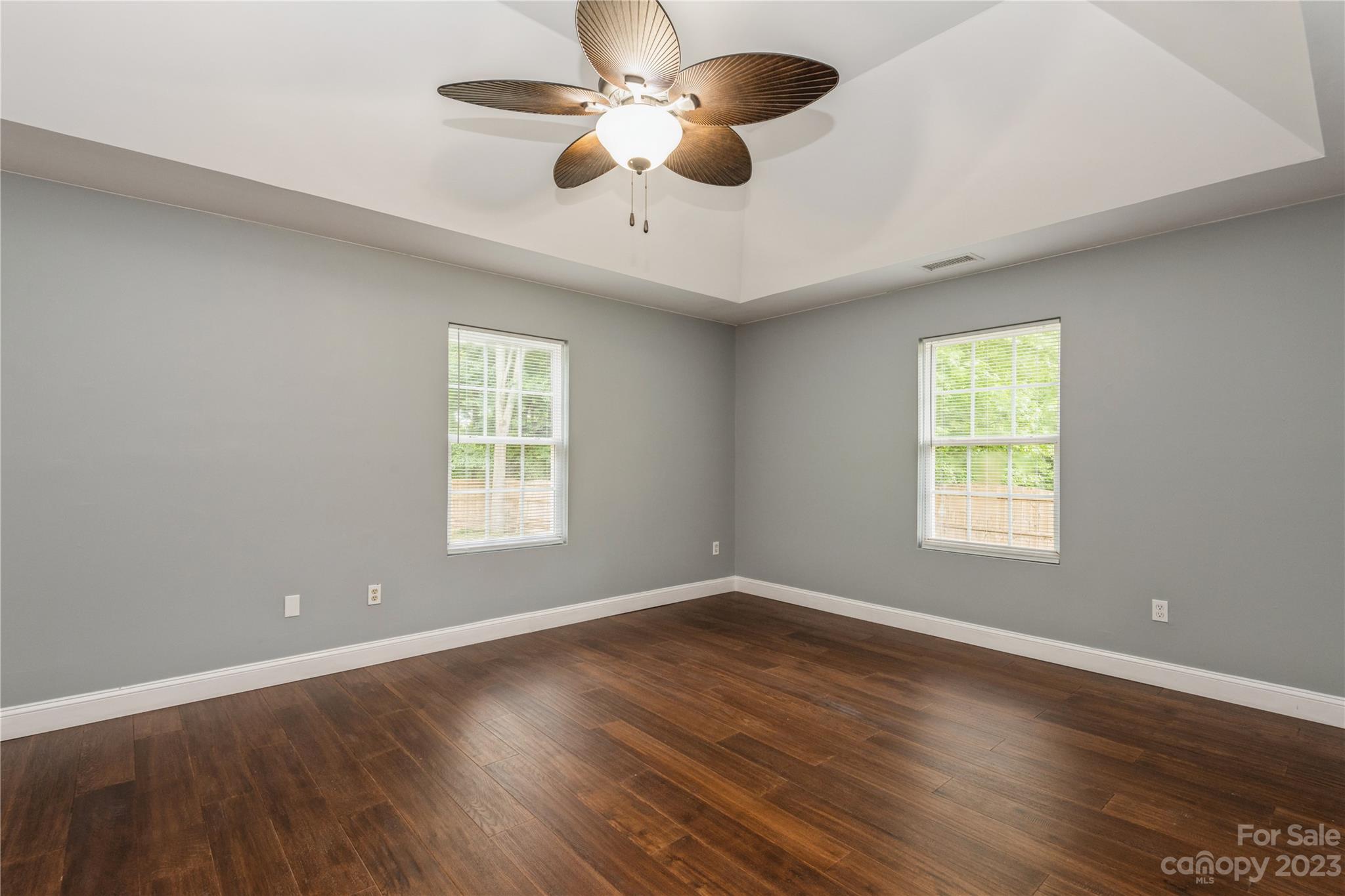 125 Rhyne Station Road Charlotte, NC 28214 - Photo 20 of 26 a view of an empty room with wooden floor and a window