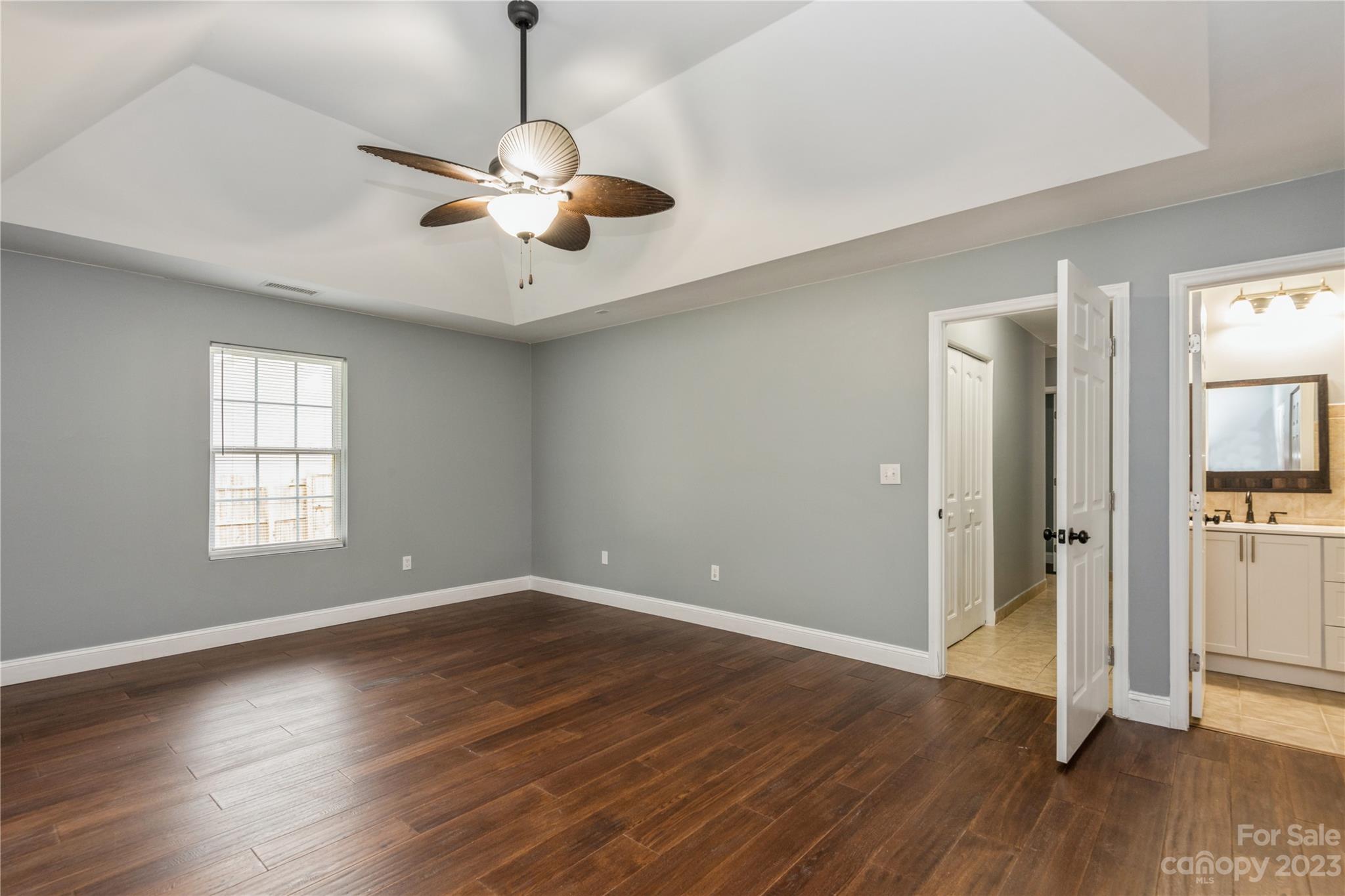 125 Rhyne Station Road Charlotte, NC 28214 - Photo 21 of 26 a view of an empty room with wooden floor and a window