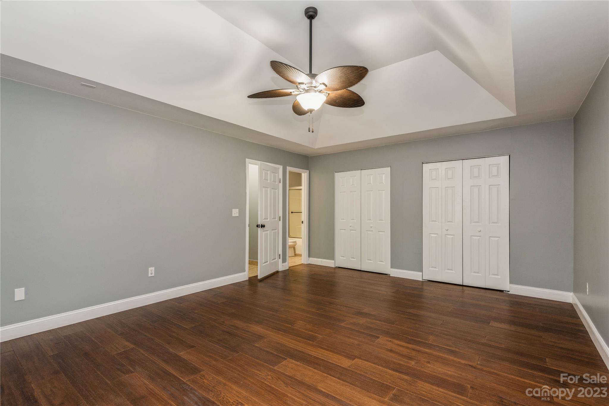 125 Rhyne Station Road Charlotte, NC 28214 - Photo 22 of 26 a view of an empty room with wooden floor and a ceiling fan