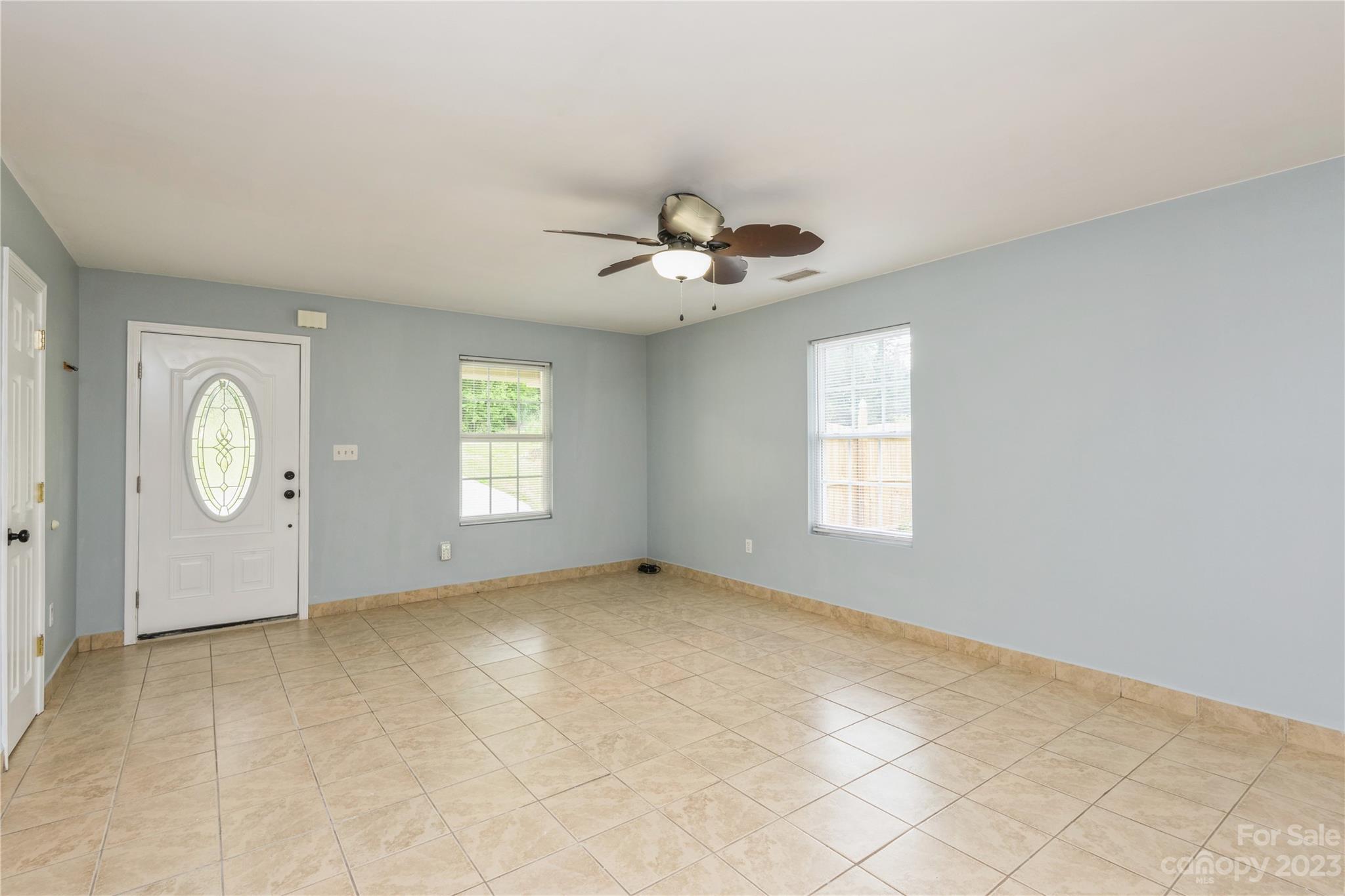 125 Rhyne Station Road Charlotte, NC 28214 - Photo 4 of 26 an empty room with windows and fan