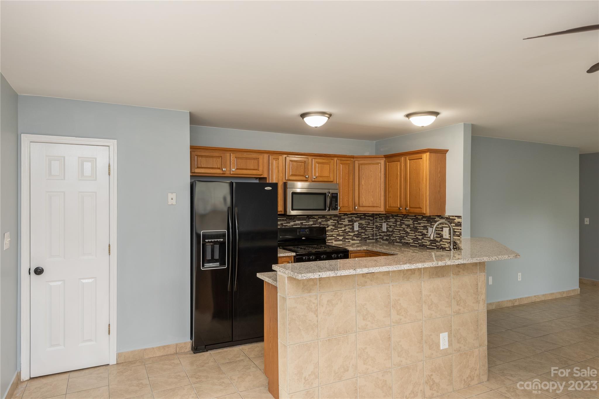125 Rhyne Station Road Charlotte, NC 28214 - Photo 7 of 26 a kitchen with a stove and a refrigerator