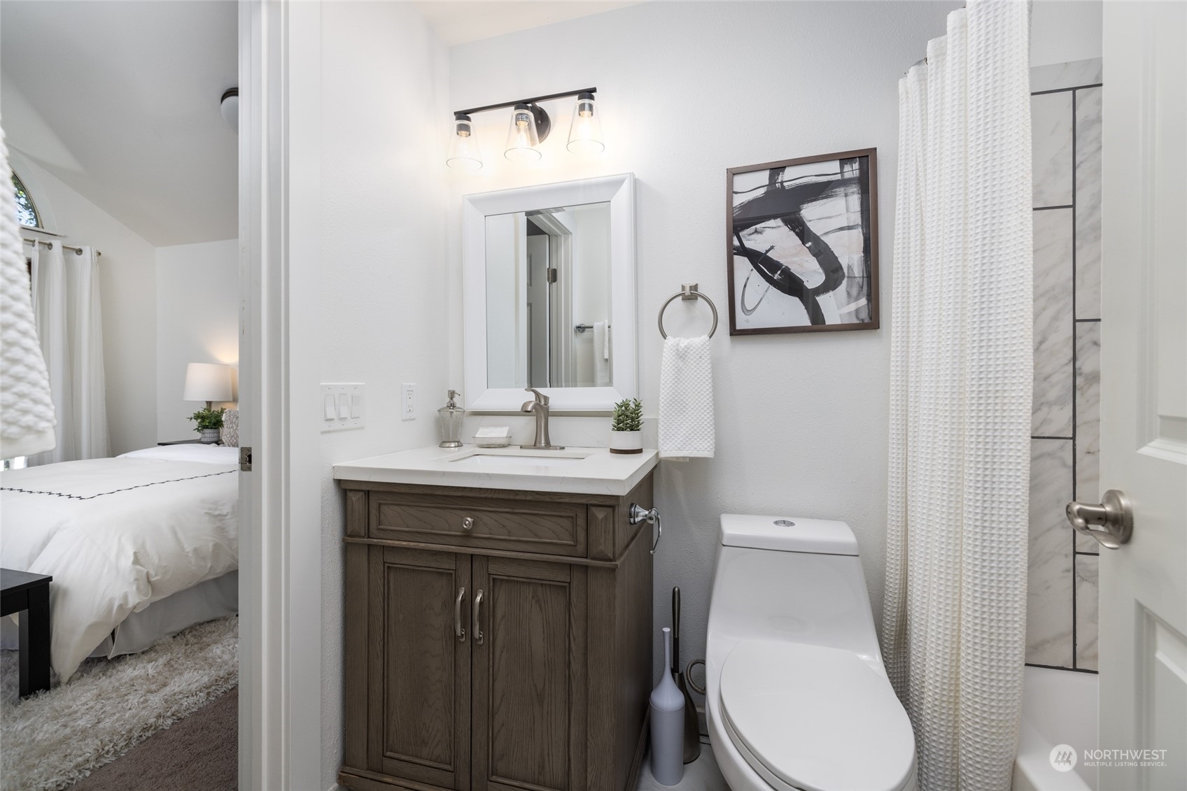 2131 North 88th Street Seattle, WA 98103 - Photo 13 of 28 a bathroom with a toilet a sink and mirror