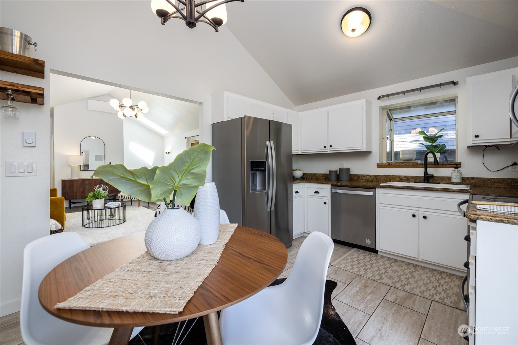 2131 North 88th Street Seattle, WA 98103 - Photo 16 of 28 a kitchen with stainless steel appliances granite countertop a refrigerator a stove a sink dishwasher with a dining table and chairs